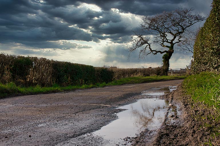 country lane with potholes